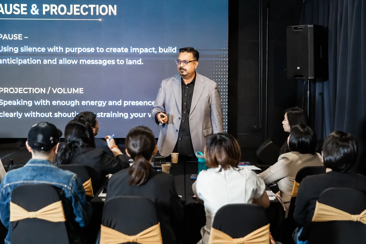 Navin Nair teaching vocal delivery to a seated audience
